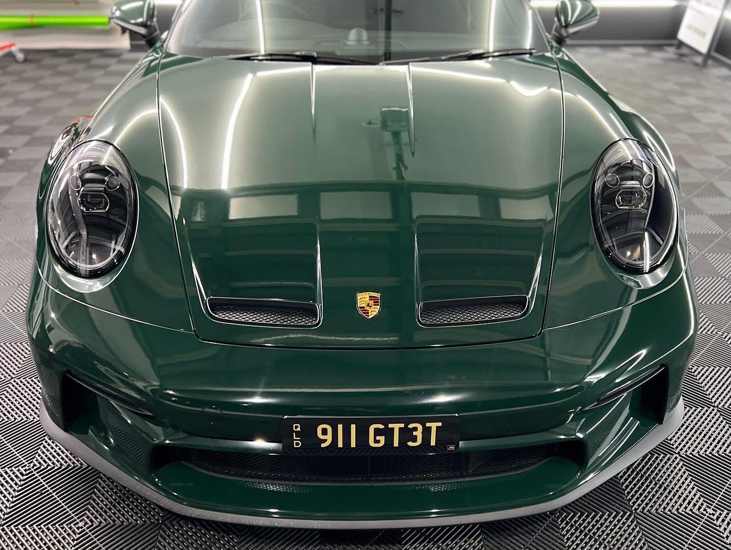 Gloss paint protection film on a green Porsche 911 GT3